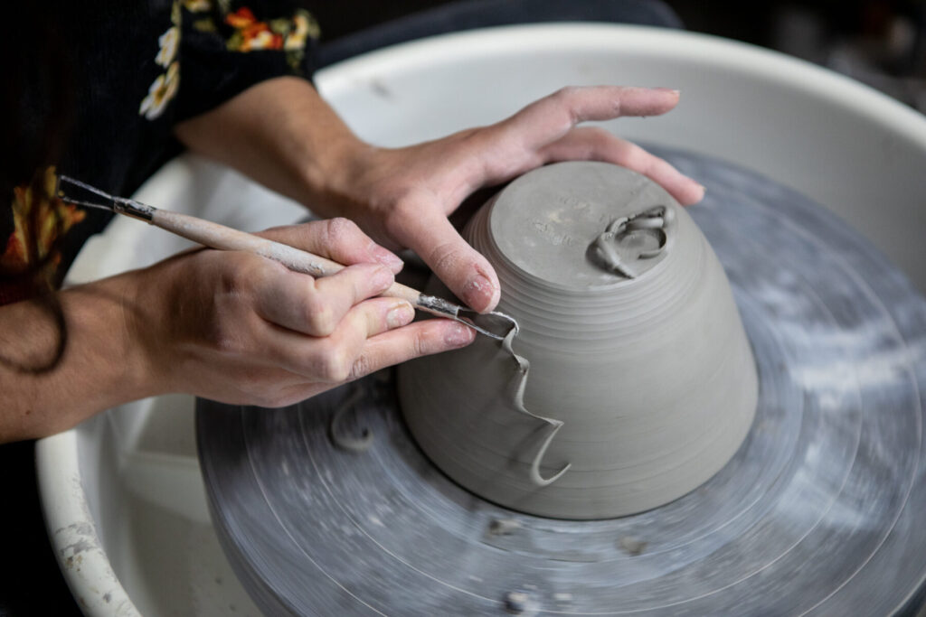 Hands at a potter's wheel.