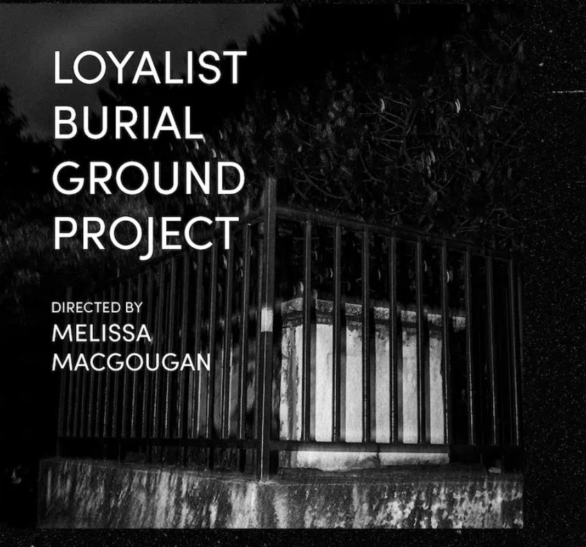 A raised grave in the Loyalist Burial ground enclosed in a wrought-iron fence. Text reads, Loyalist Burial Ground Project, directed by Melissa MacGougan.