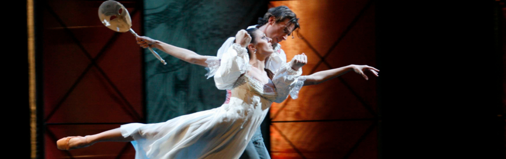 Two dancers onstage in a scene from the Phantom of the Opera.